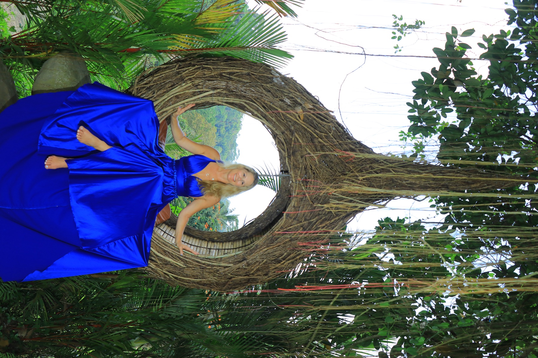 Tracy in blue dress in tropical setting